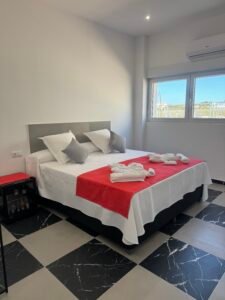 B6_Medium_101 Bathed in natural light, our elegantly spacious bedroom offers a serene retreat, where airy design and soft tones create a haven of relaxation and comfort.